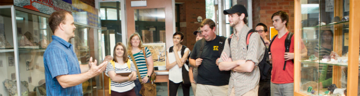 group of students listening to an instructor inside a museum